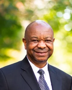Man in suit standing outdoors.