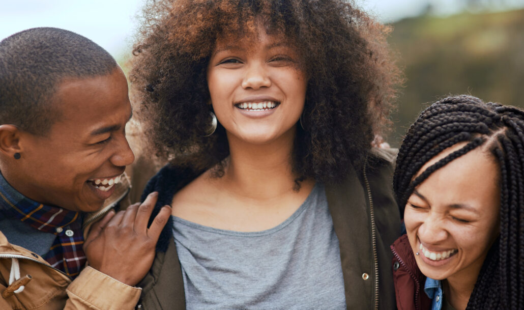A collage of four photos of a group of people, smiling and enjoying each other's company.