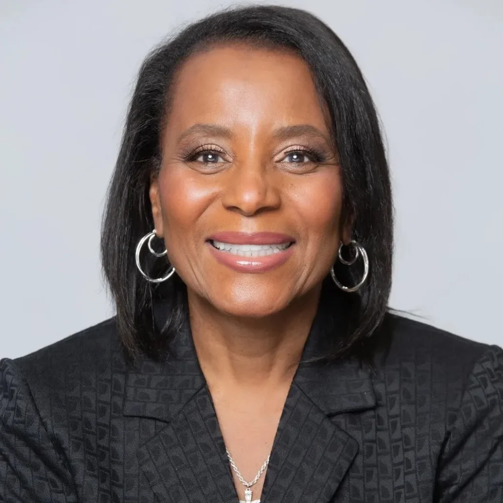 Woman in suit smiling at camera.