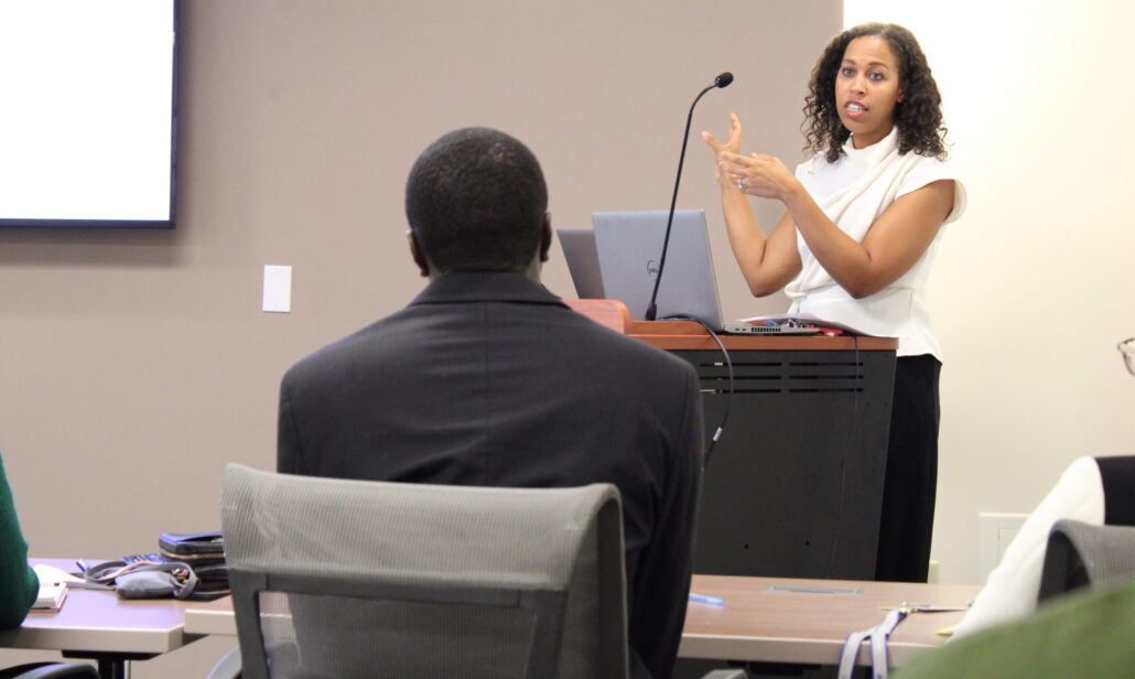 Woman giving presentation in conference room.