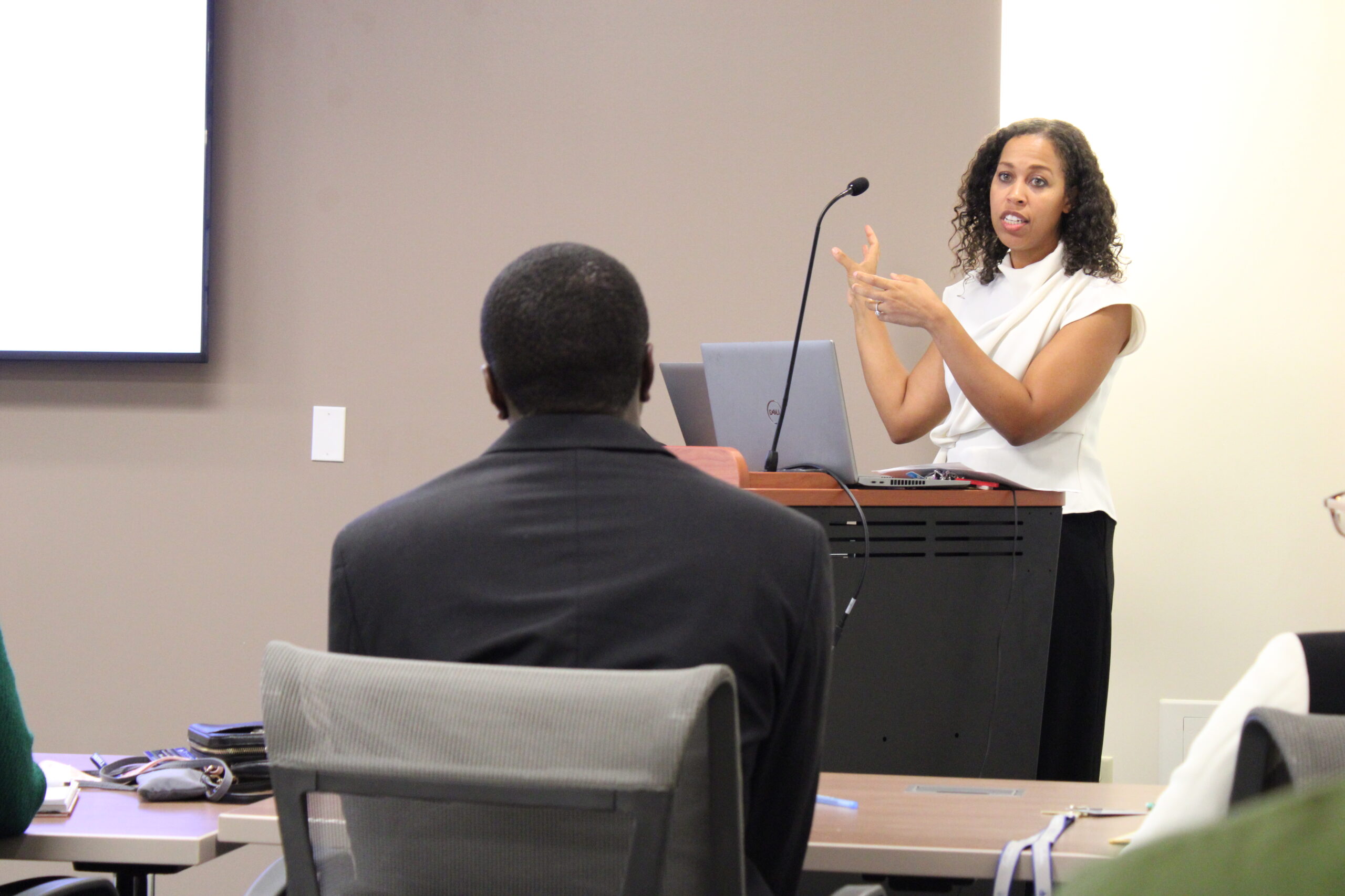 Woman giving presentation in conference room.