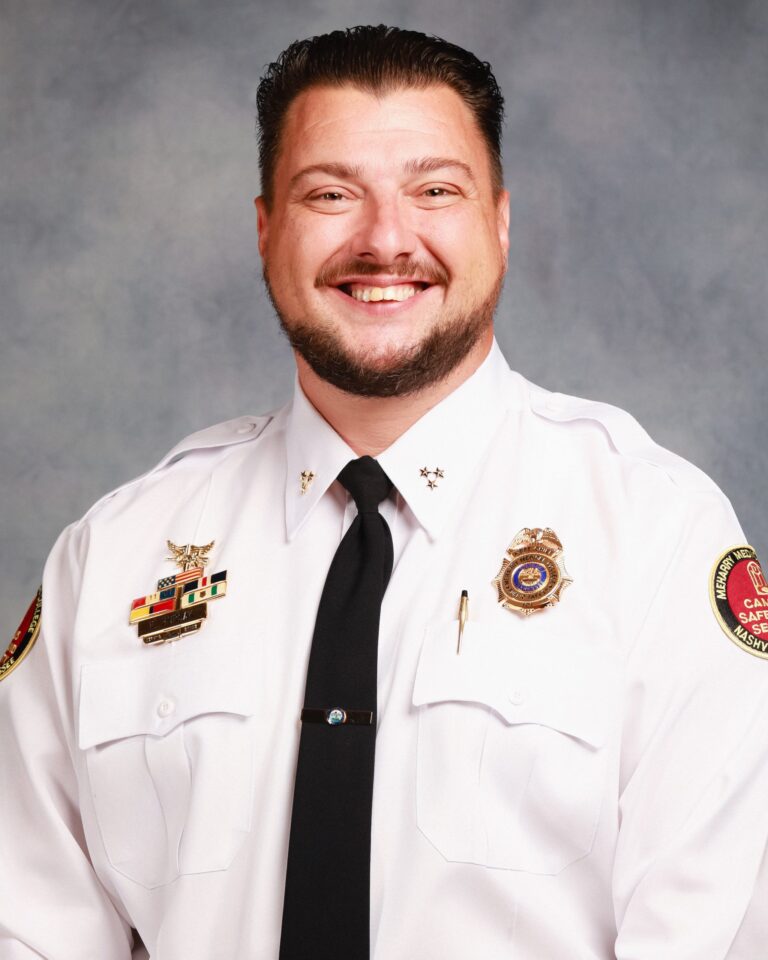 Police officer in uniform posing for photo.