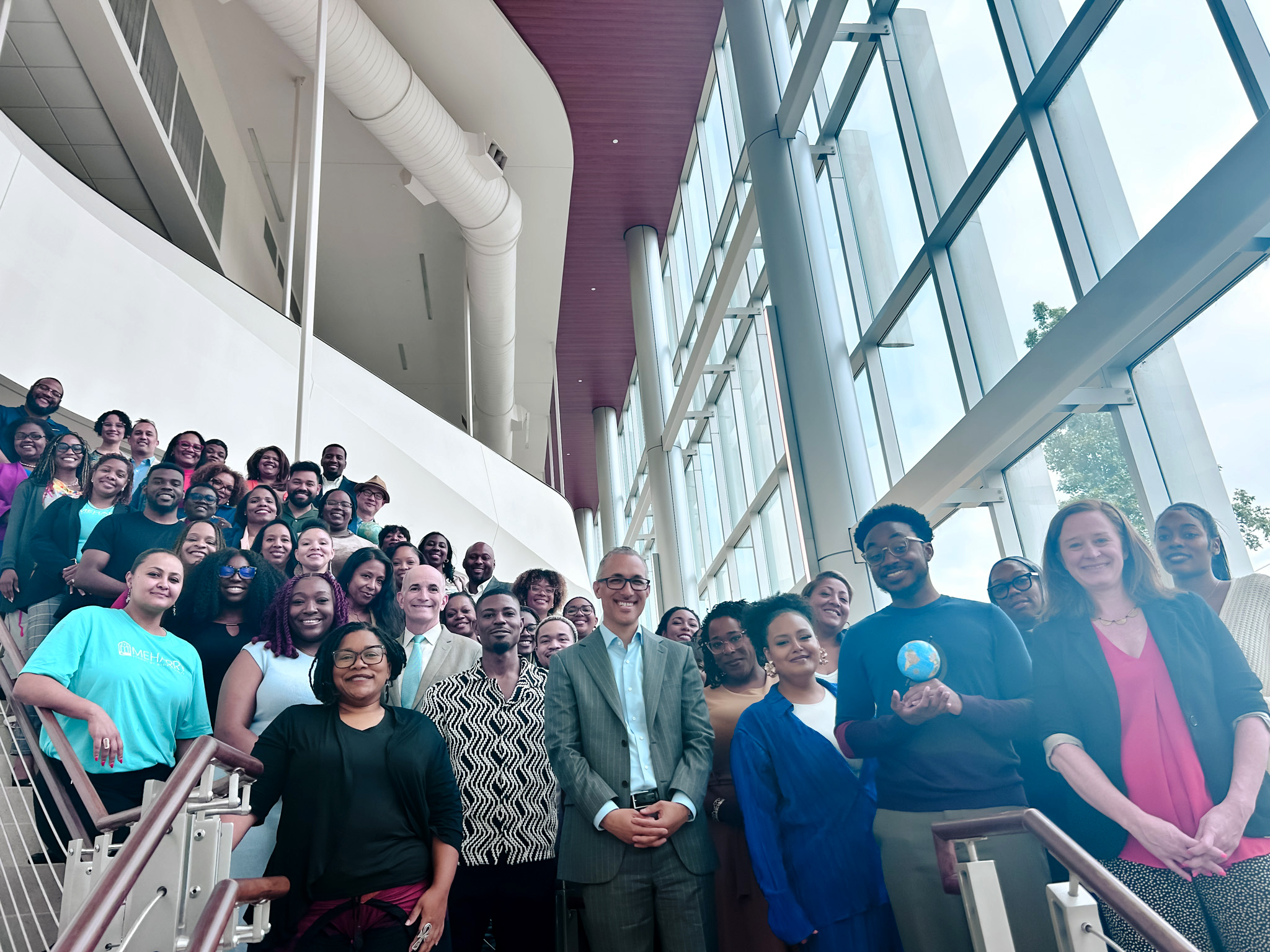 A group of people posing for a photo in a building lobby.