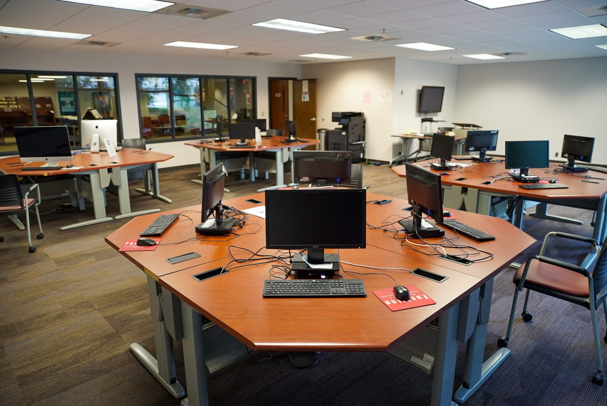 Computer lab with many desks and monitors.