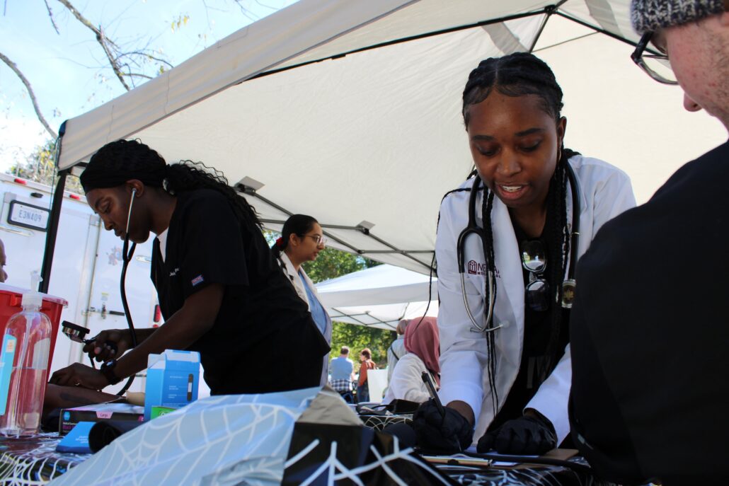 A tent with people preparing food.