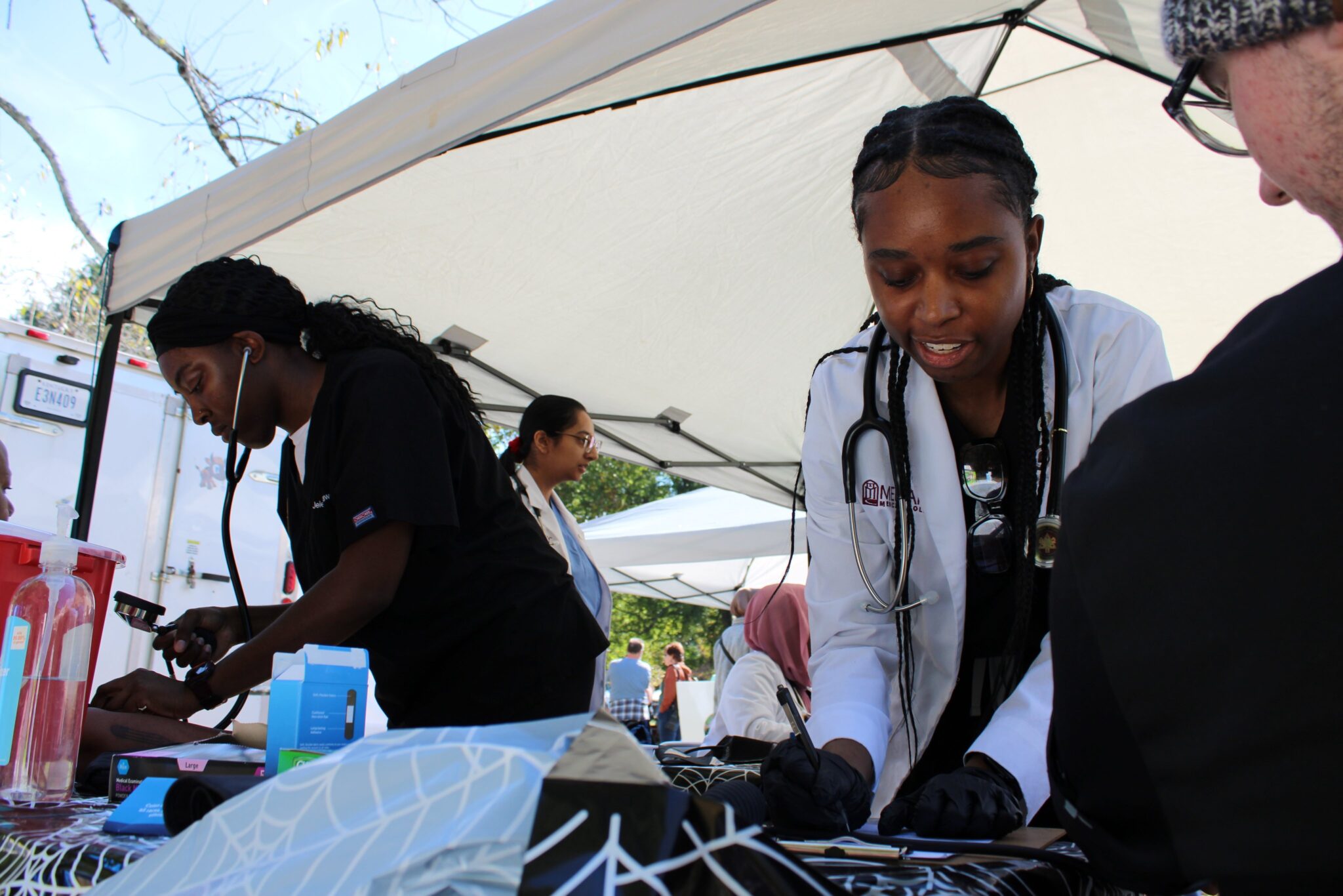 A tent with people preparing food.