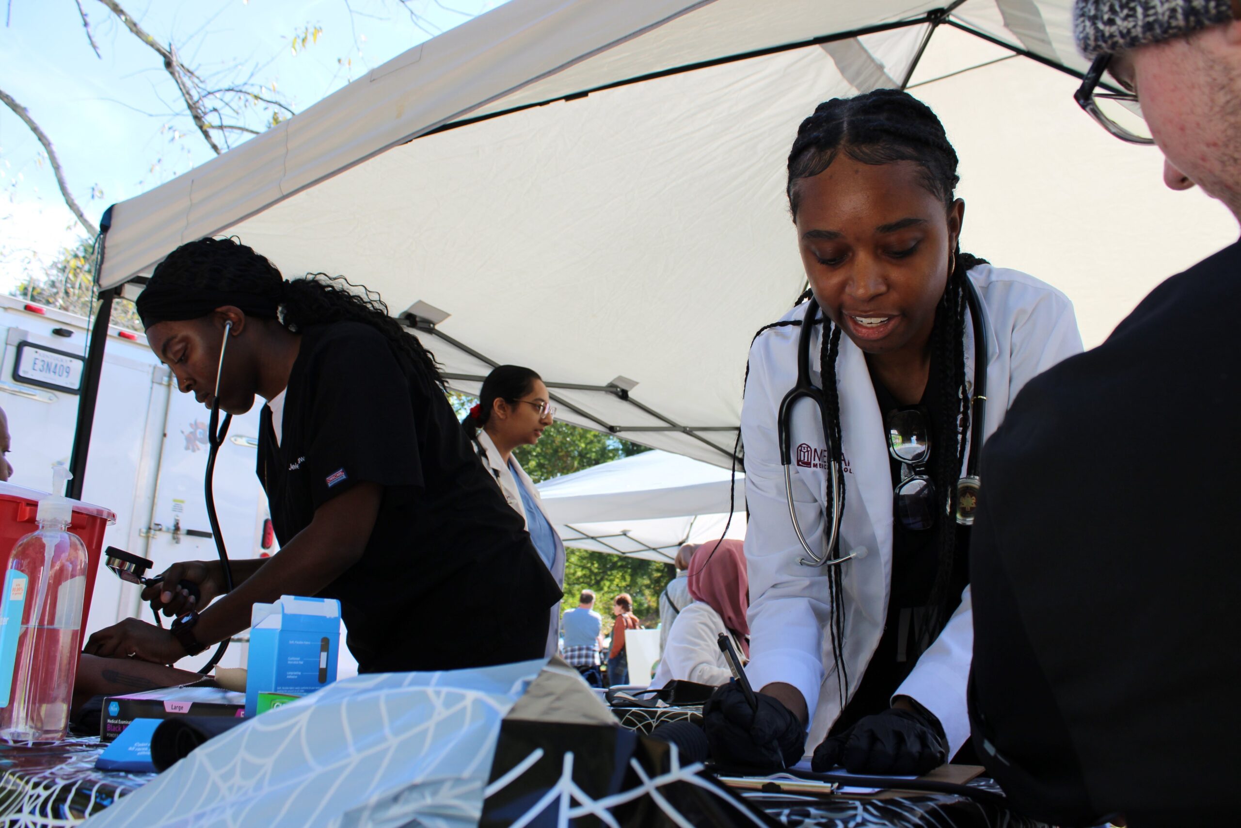 A tent with people preparing food.