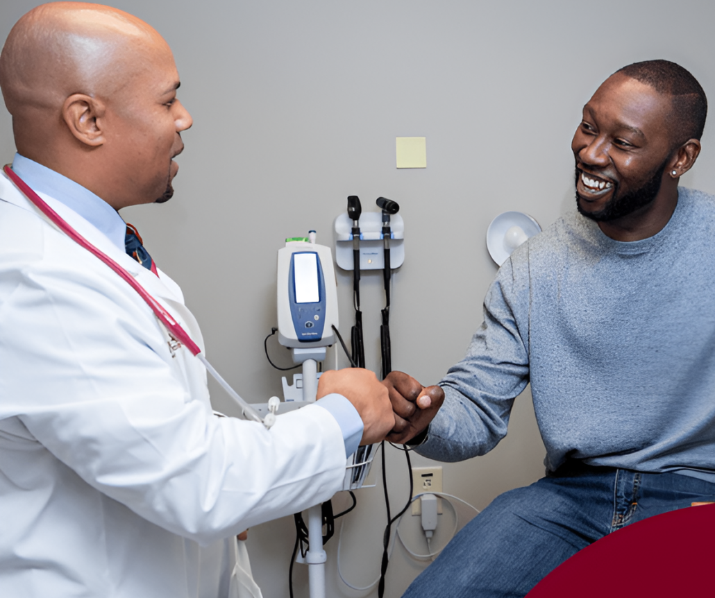Man shaking hands with doctor in medical office.