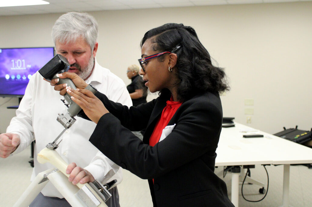 Two people examining a microscope.