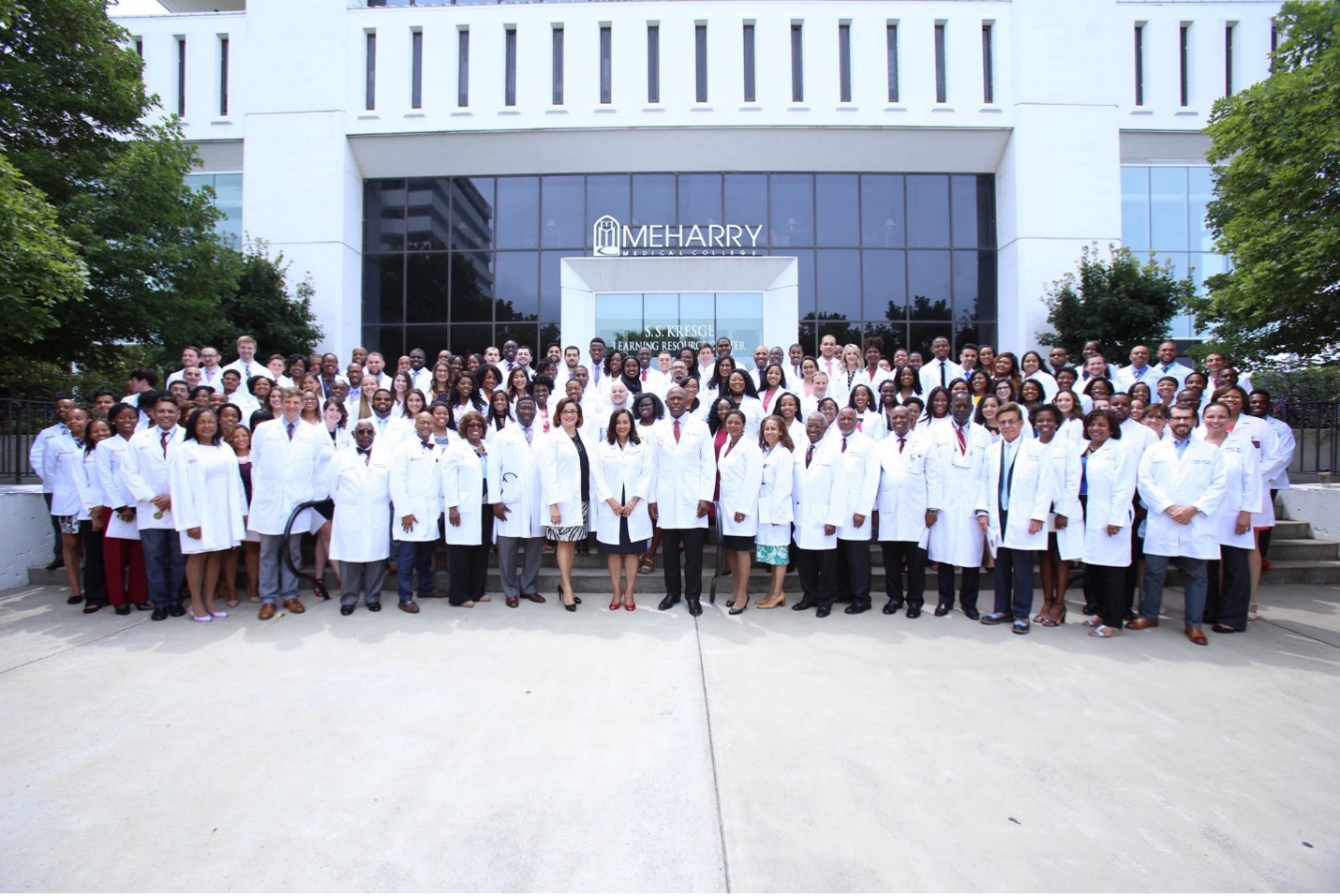 A group of people posing for a photo in front of a building.