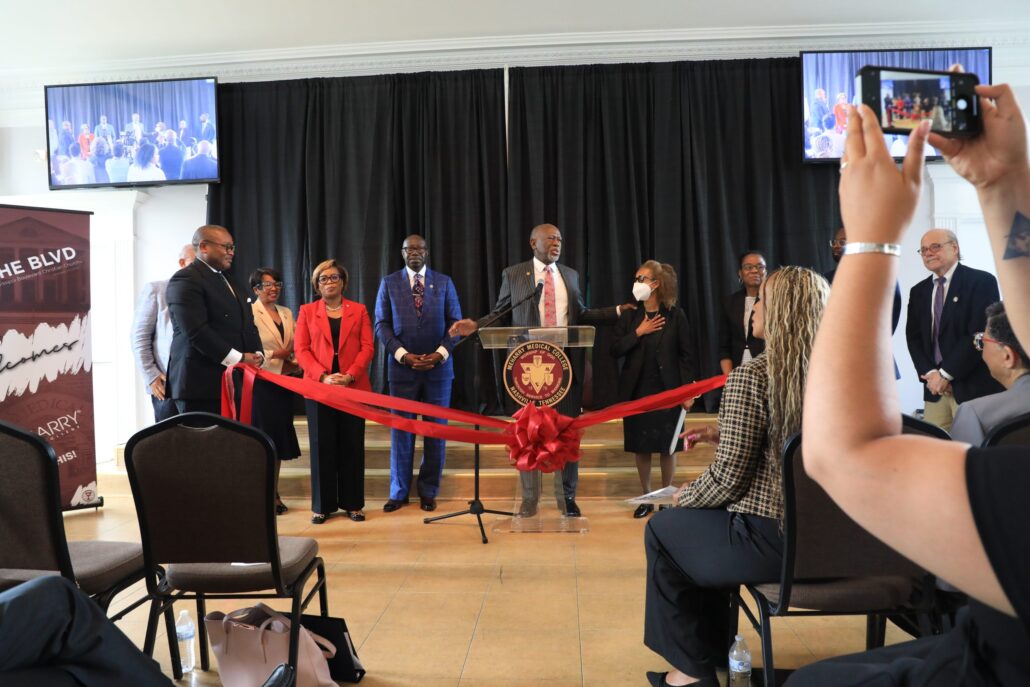 A group of people standing behind a podium at a conference.