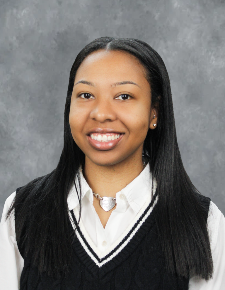 Woman in school uniform posing for portrait.