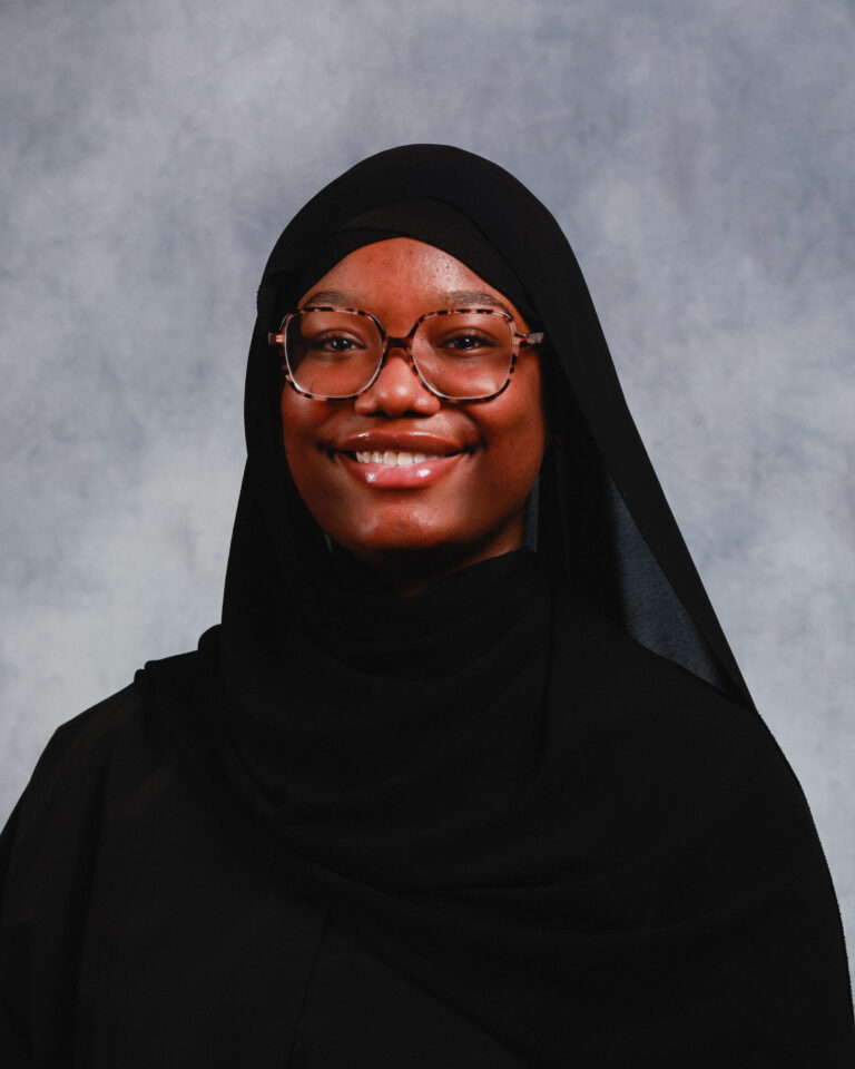 A young woman in a hijab posing for a portrait.