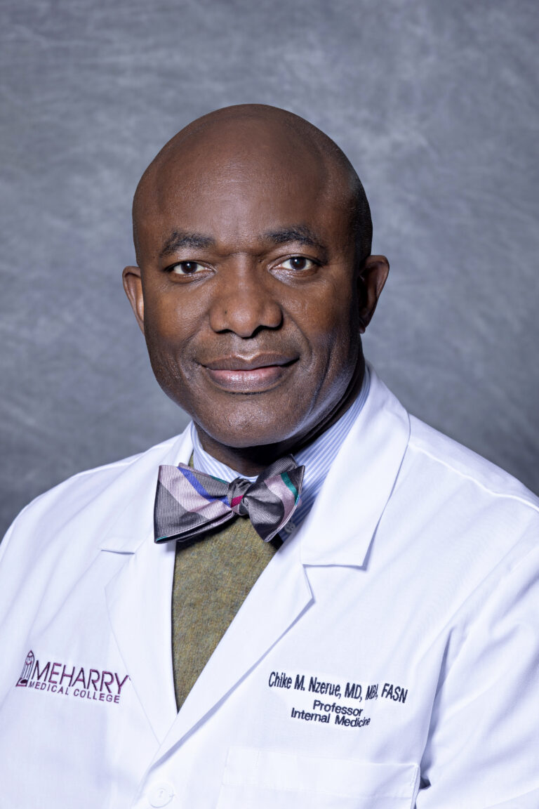 A man in a lab coat posing for a portrait.