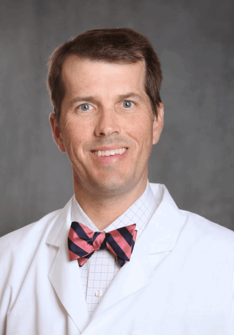 Man in a lab coat and bow tie.