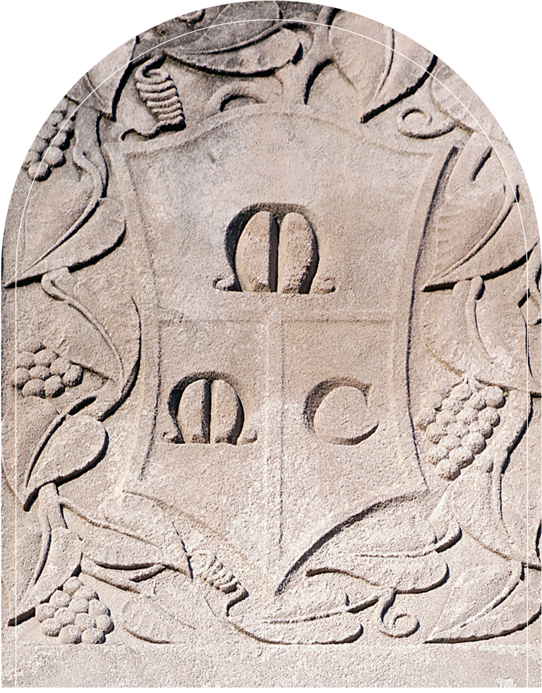 Stone plaque with coat of arms, featuring a shield, two crowns, and a crest.