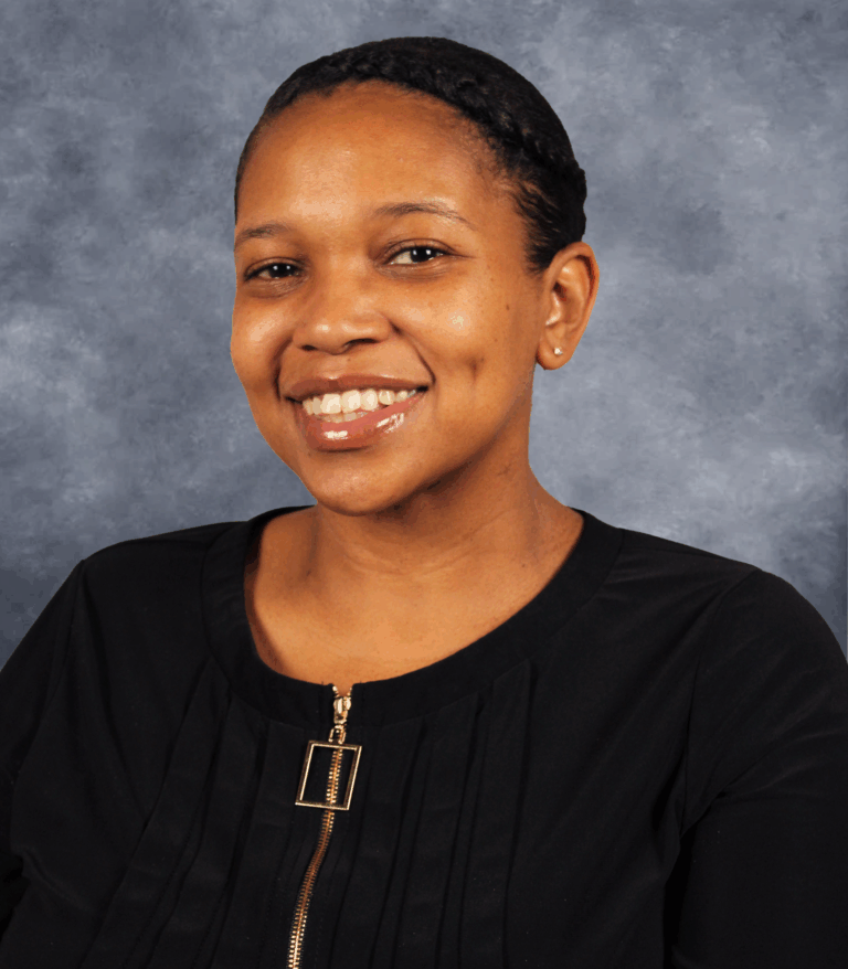 Woman in a black shirt smiling at the camera.