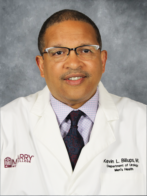 Man in white coat posing for portrait.