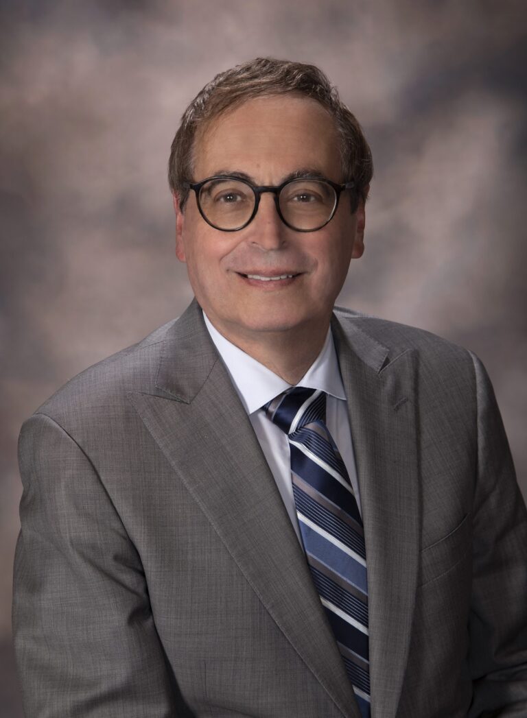 Man in suit posing for portrait.