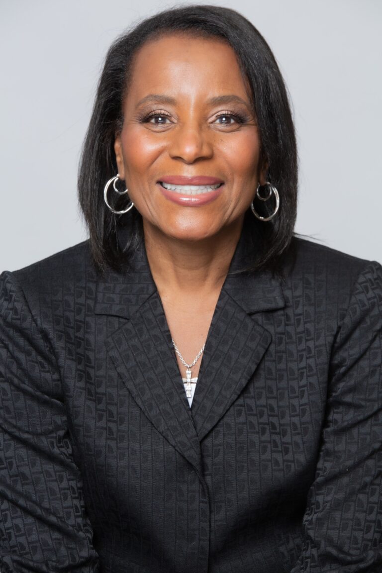 Woman in suit posing for portrait.