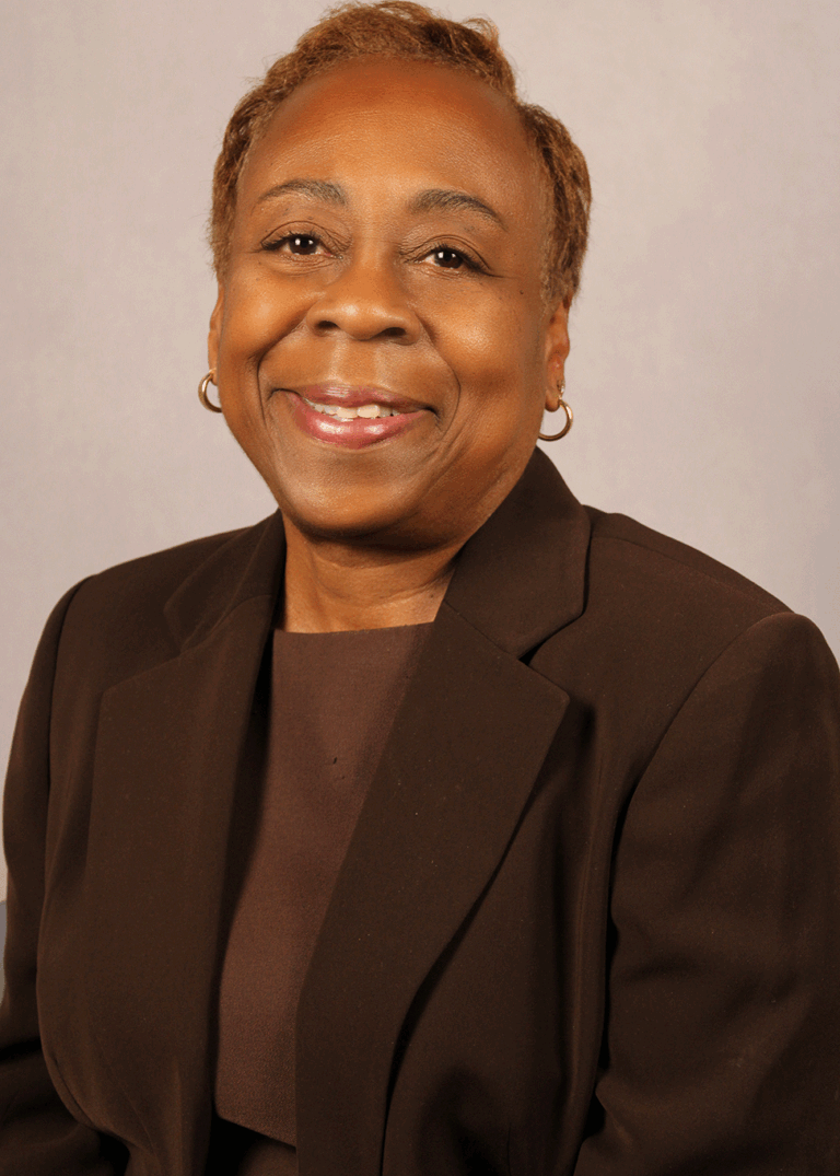 Woman in suit smiling at camera.