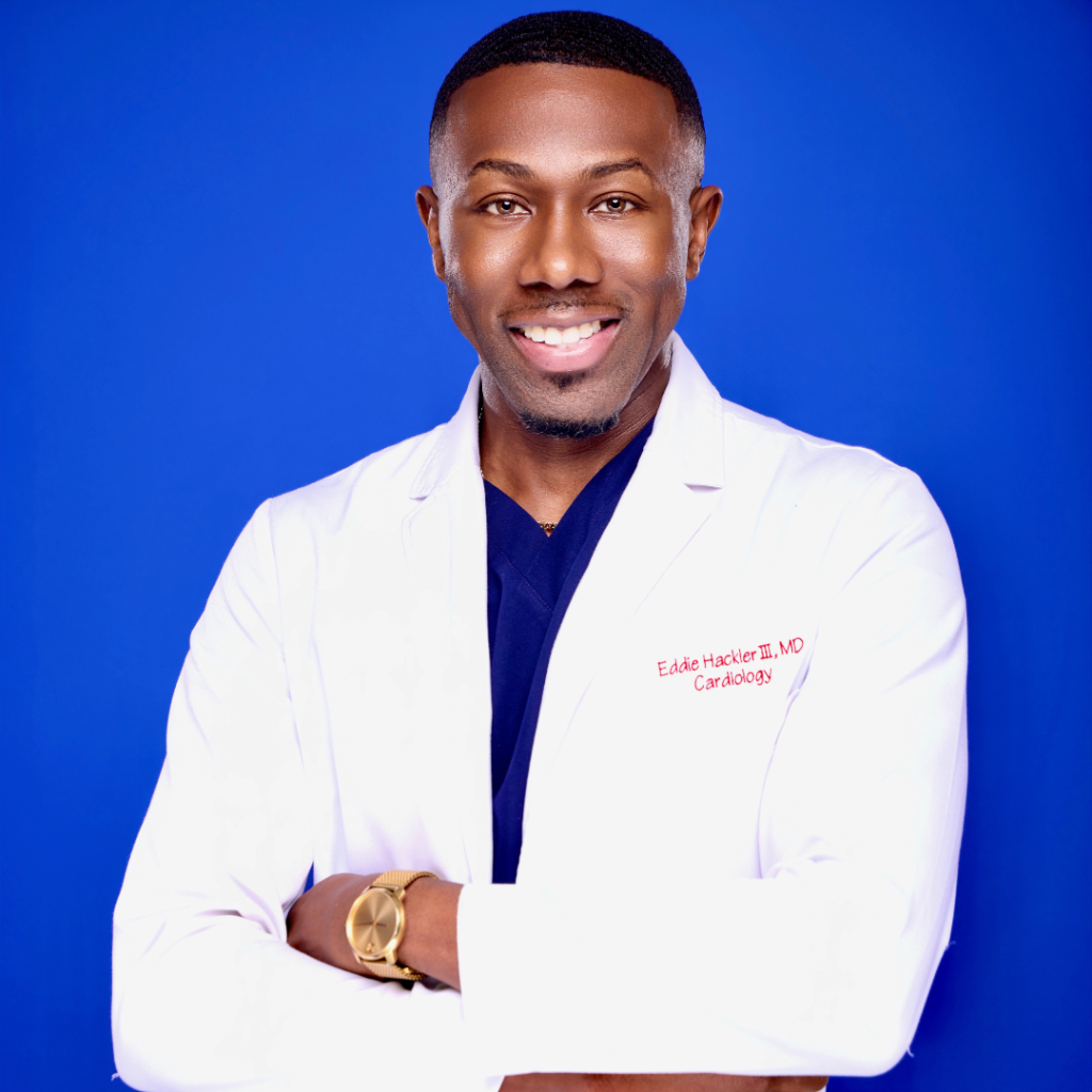 Man in white coat standing confidently.