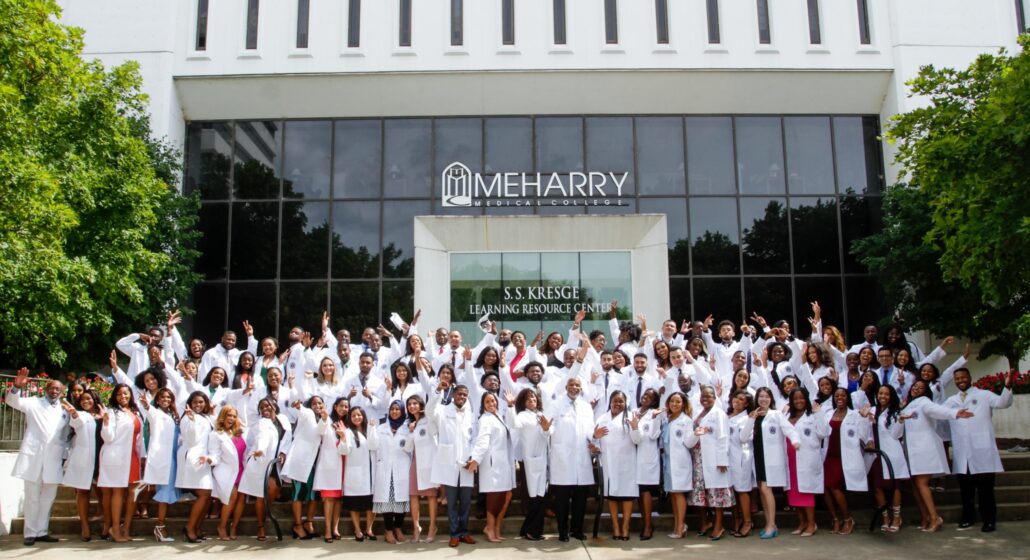 A group of people posing in front of a building.