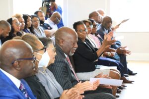 Group of people clapping in a room.