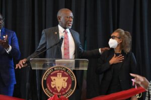 A man in suit addressing a crowd.
