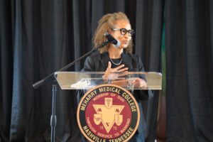 Woman speaking at podium, microphone, name tag, podium with name, microphone, podium with name, podium with name, podium with name, podium with name, podium with name, podium with name, podium with name, podium with name, podium with name, podium with name, podium with name, podium with name, podium with name, podium with name, podium with name, podium with name,