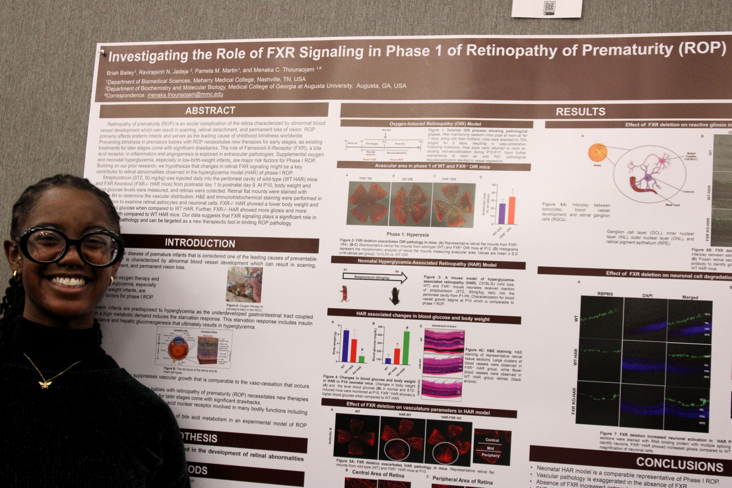 Two people standing in front of a poster board with information about a scientific study.