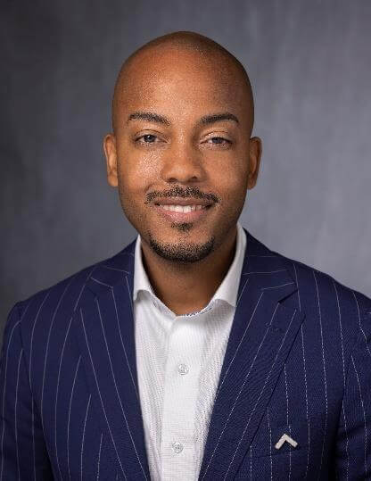 Man in suit posing for portrait.