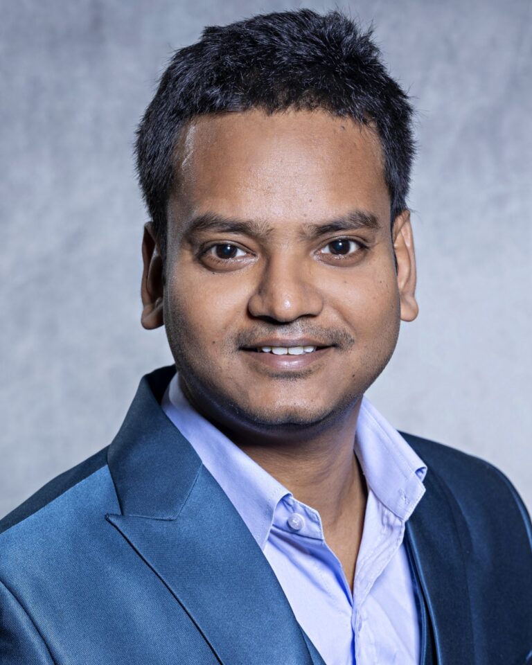 Man in suit posing for portrait.