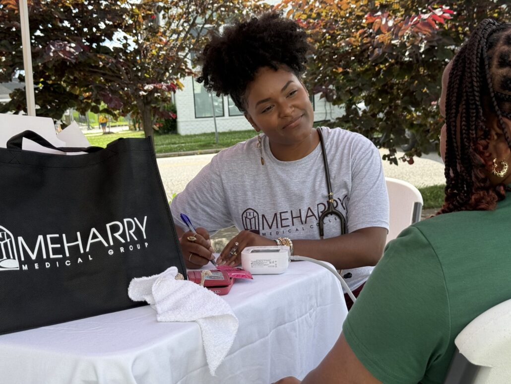 Meharry Medical Group resident providing health screenings at Black on Buchanan event in North Nashville.