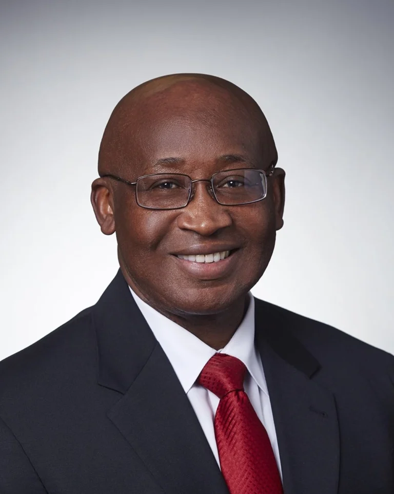 Man in suit smiling at camera.