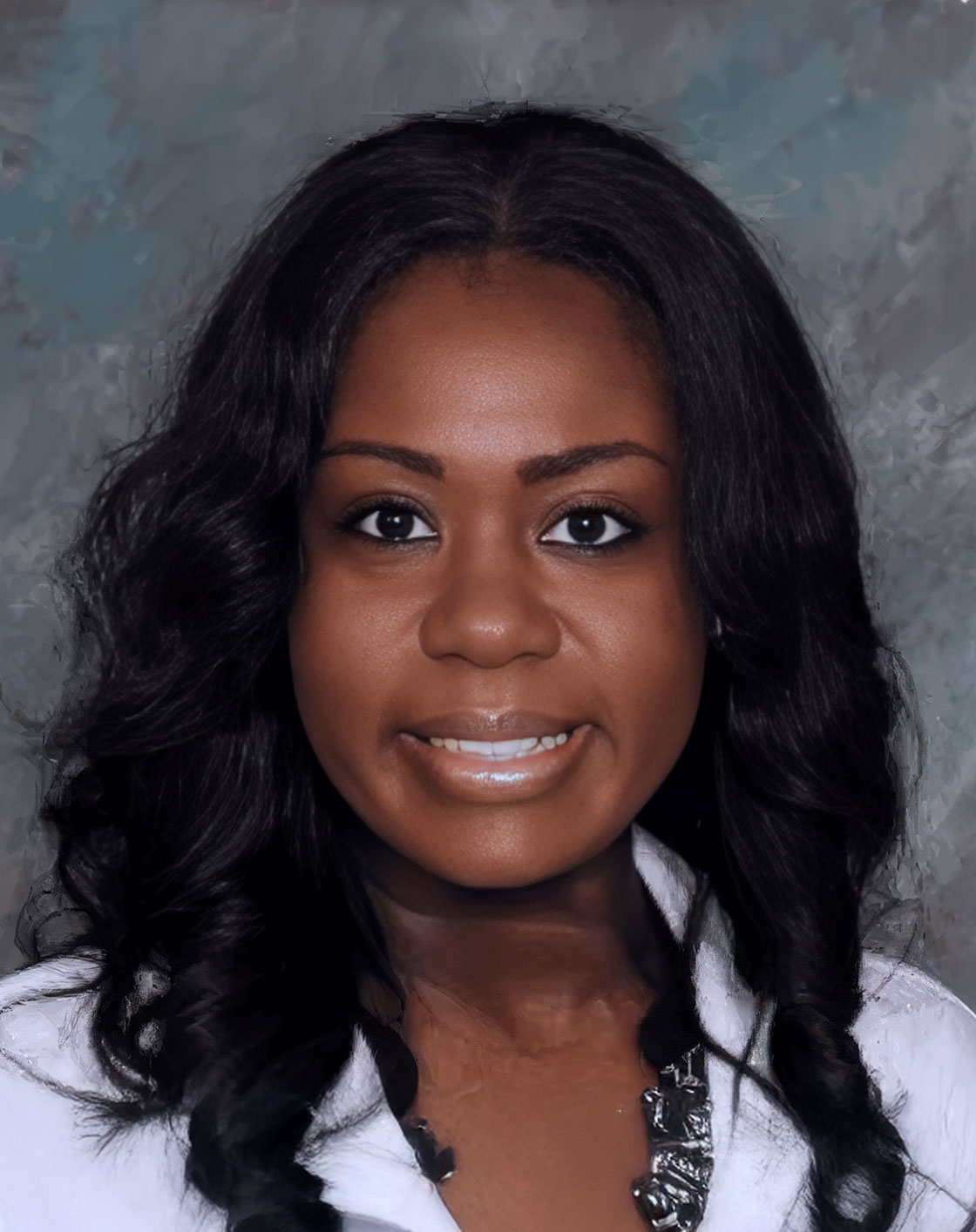 Woman in white coat, smiling, posing for portrait.