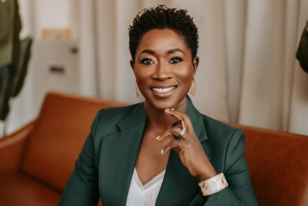 Woman in business attire posing for photo.