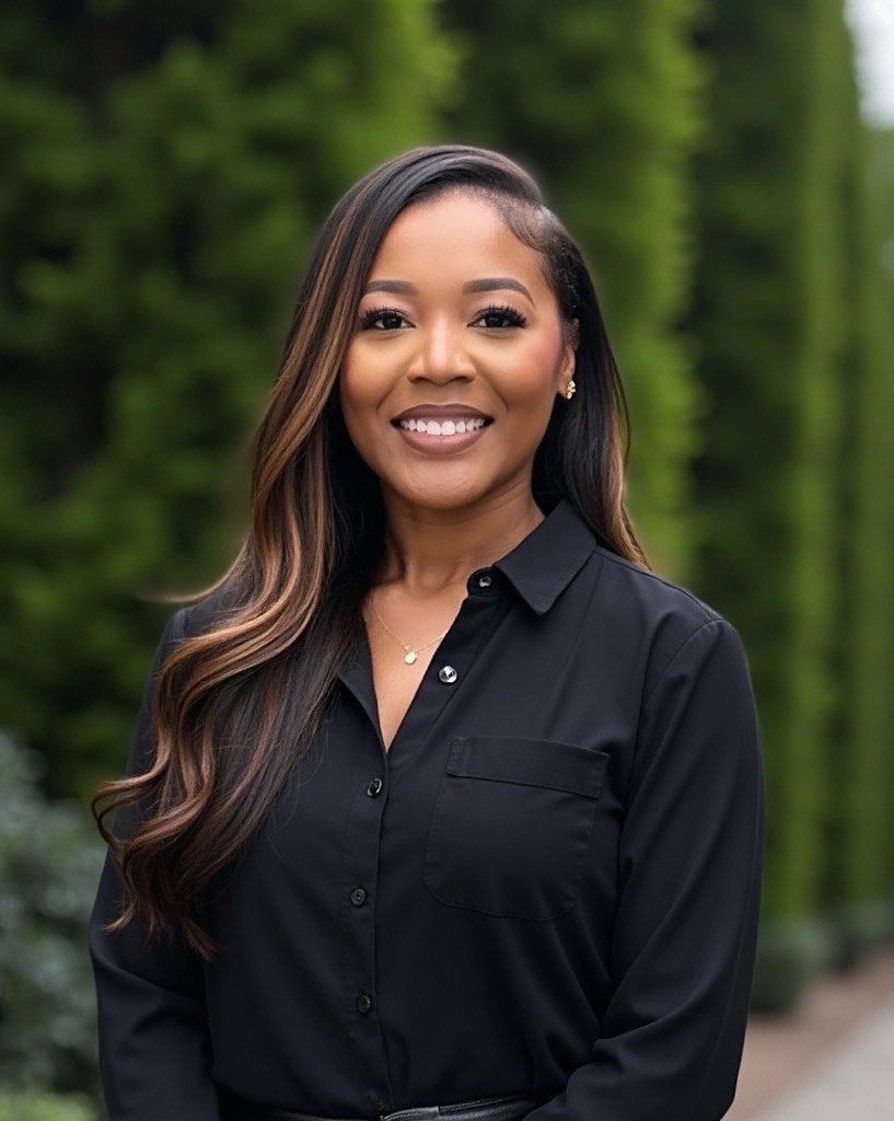 A woman in a black shirt posing for a portrait.