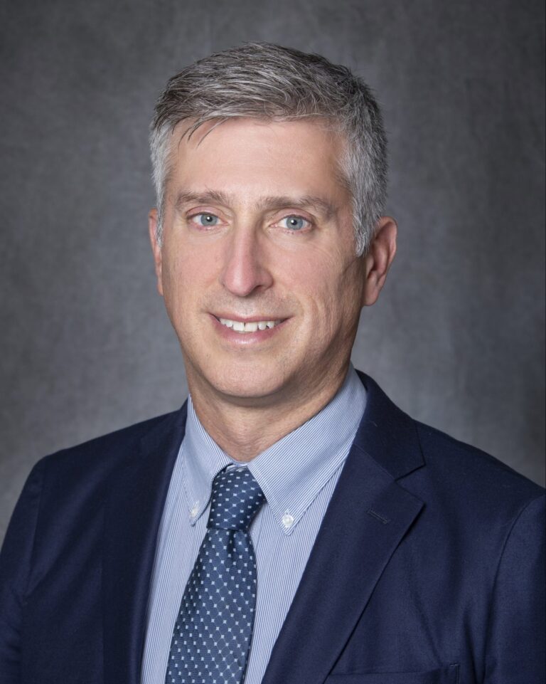 Man in suit posing for portrait.