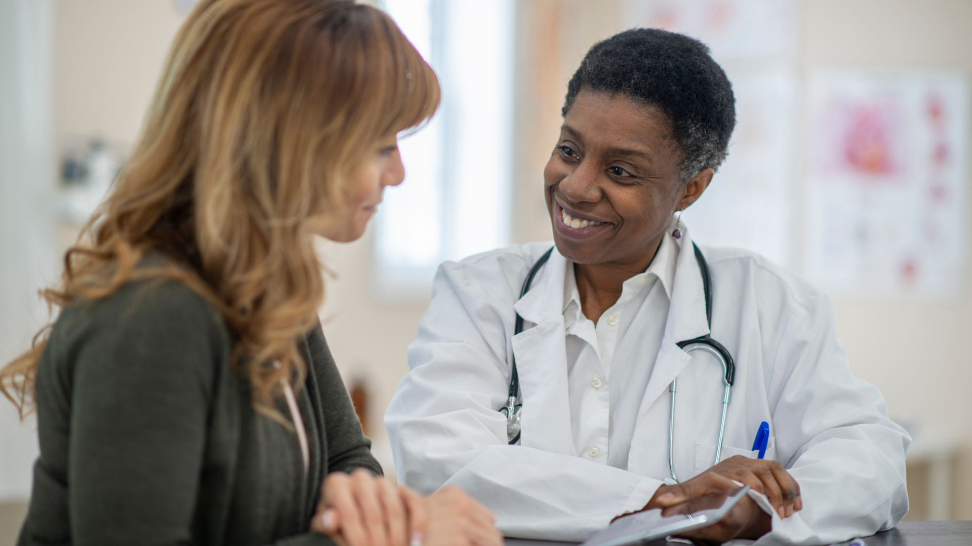 Woman smiling at another.