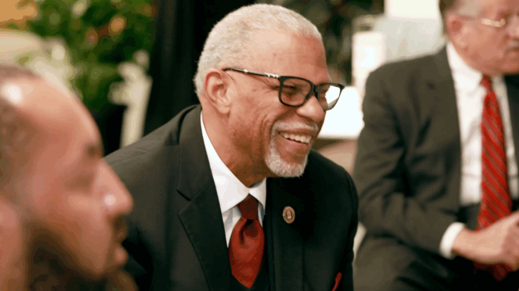 Man in suit sitting at table.