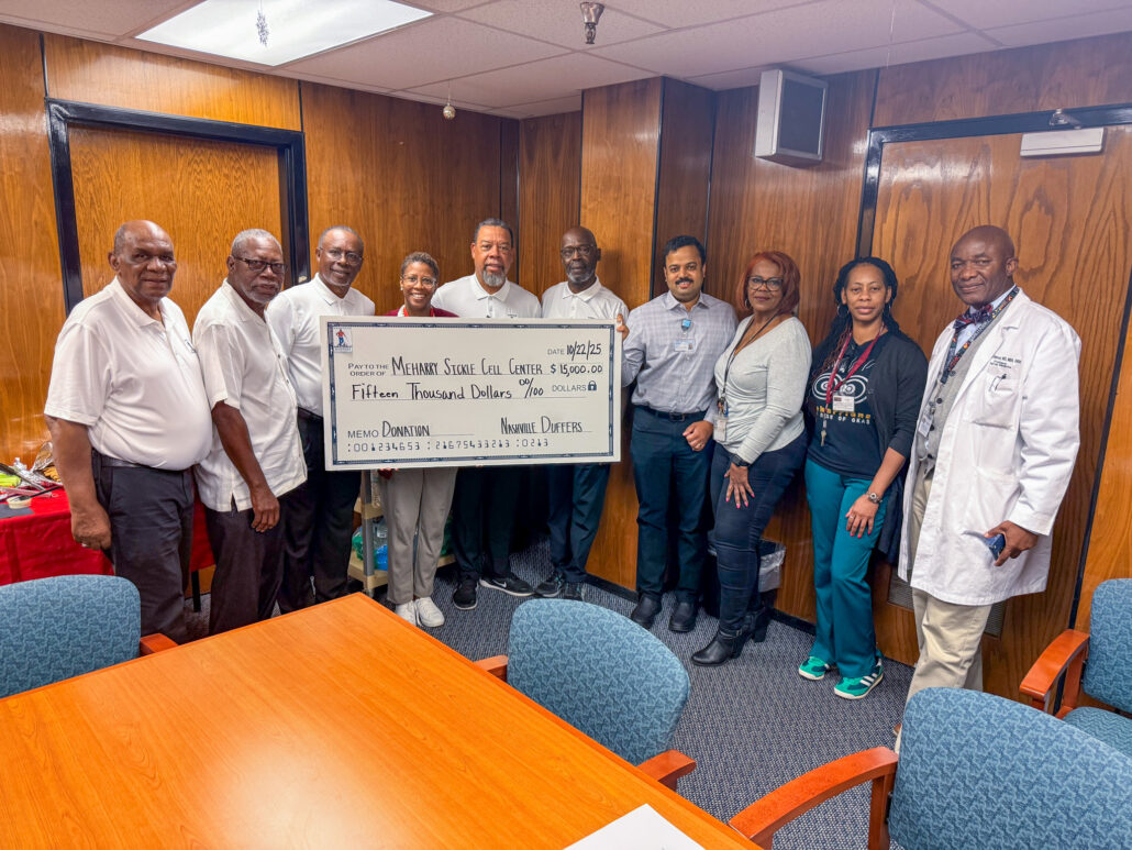 Group of people posing with a check.