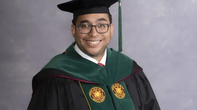 Man in graduation cap and gown.