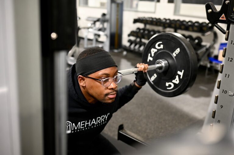 Student weightlifting in gym