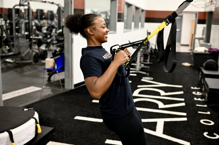 student using exercise equipment in gym