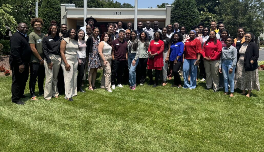 A group of people posing for a photo in front of a building.