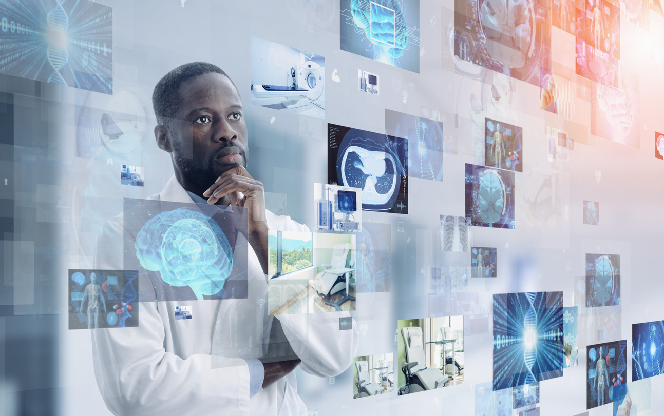 A man in a lab coat standing in front of a holographic display of images.