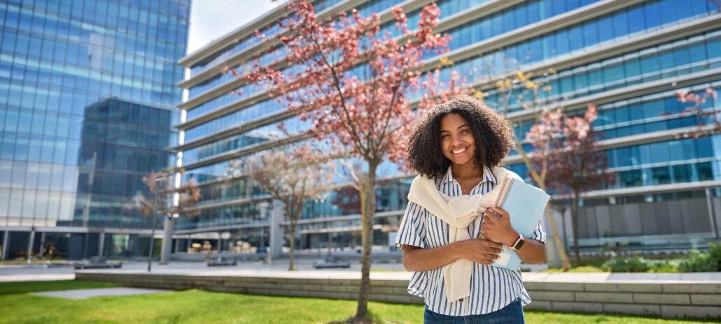 Woman standing in front of office building.