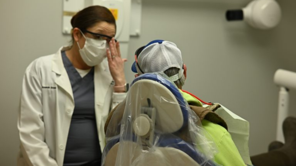 Dental provider talking to patient.