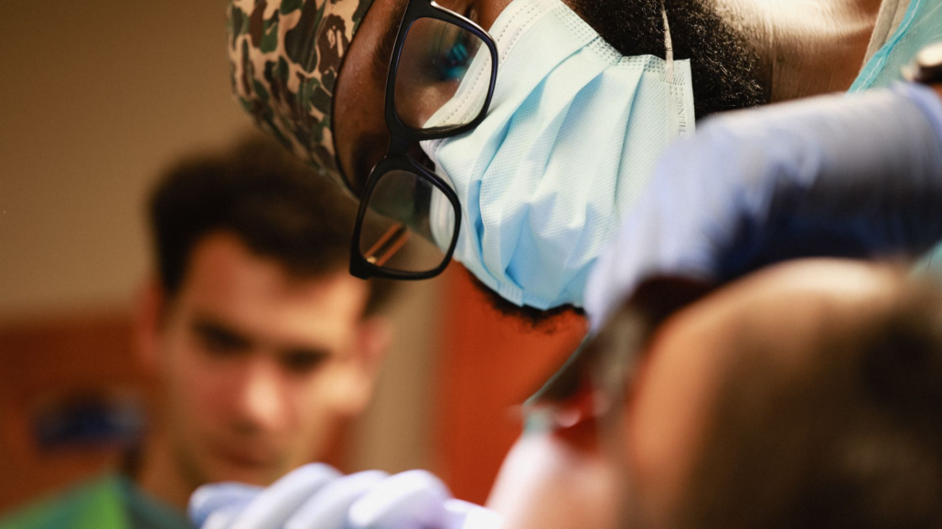 Dental provider performing dental work on patient.